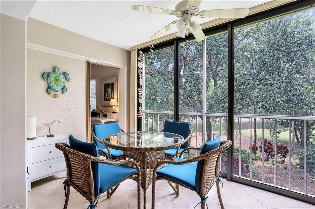 1001 Foxfire Lane, Unit 204 Naples, FL 34104 - Photo 8 of 22 a dining room with furniture a chandelier and wooden floor
