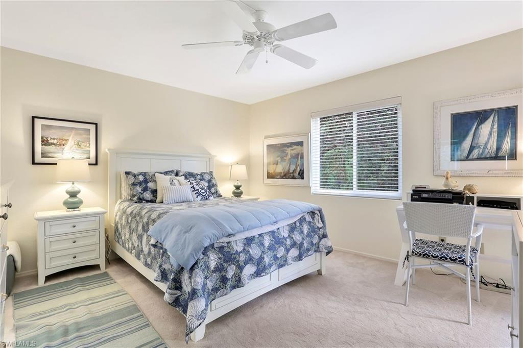 1001 Foxfire Lane, Unit 204 Naples, FL 34104 - Photo 10 of 22 a bedroom with a bed and a chair