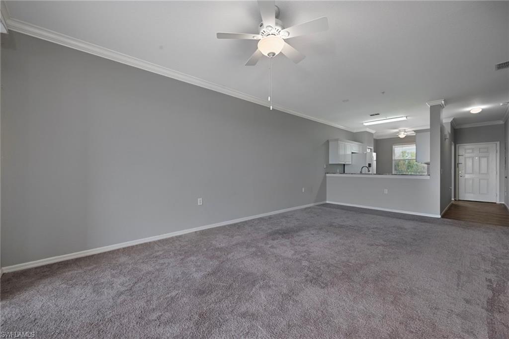 8550 Kingbird Loop, Unit 646 Estero, FL 33967 - Photo 11 of 23 an empty room with a empty space and a ceiling fan