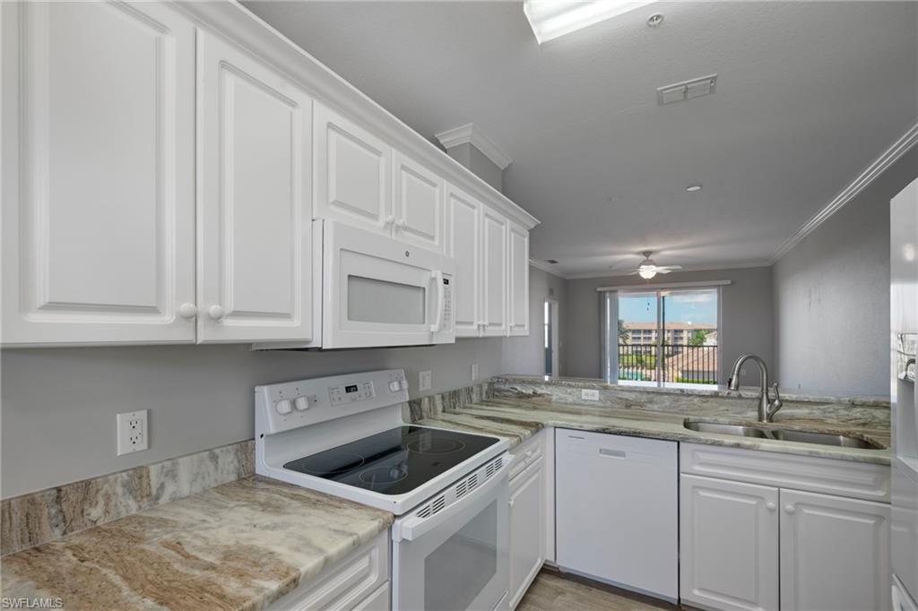 8550 Kingbird Loop, Unit 646 Estero, FL 33967 - Photo 5 of 23 a kitchen with granite countertop white cabinets and a sink