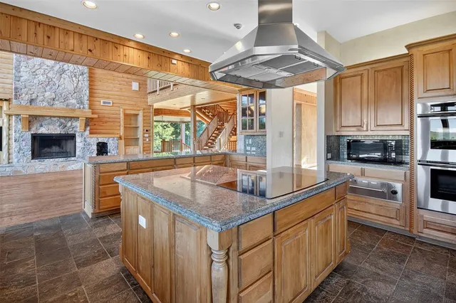 a view of a porch with wooden floor and floor to ceiling window