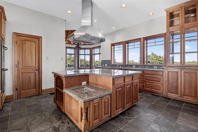 a kitchen with stainless steel appliances granite countertop a sink and cabinets