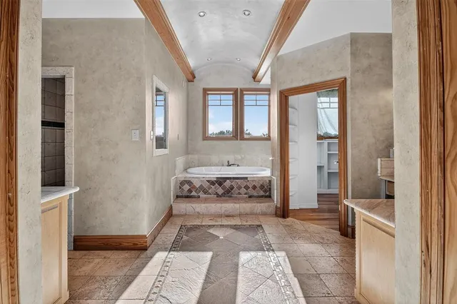 a view of a livingroom with wooden floor and a ceiling fan