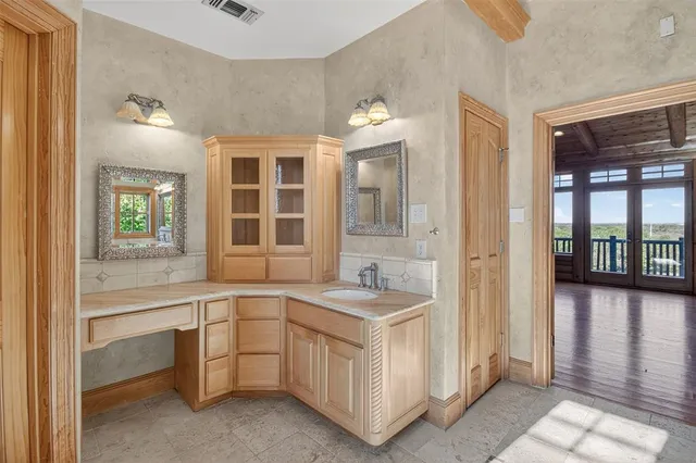 a bathroom with a tub shower and sink