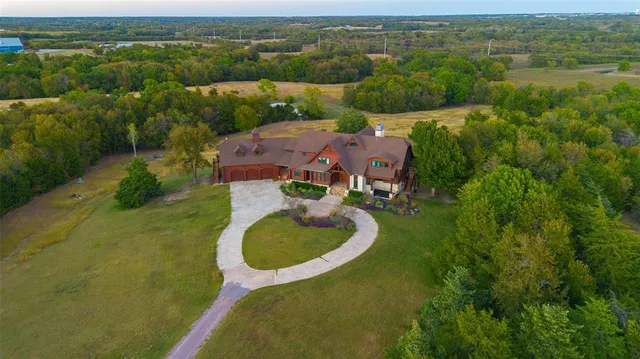 an aerial view of a house with yard