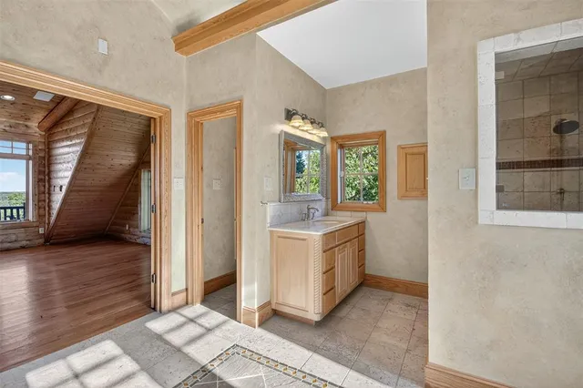 a bathroom with a sink and a window