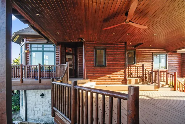 a view of a livingroom with fireplace and windows