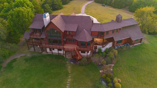 a aerial view of a house with swimming pool and garden