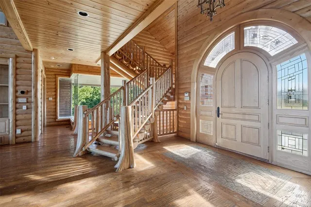 a view of a hallway with entryway wooden floor and front door