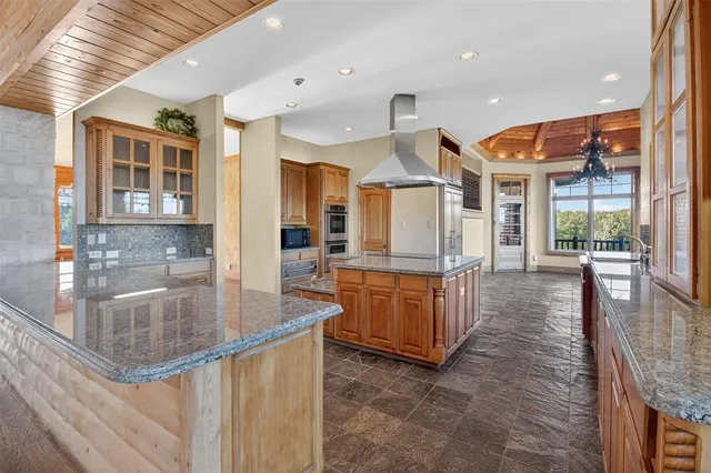 a kitchen with stainless steel appliances granite countertop a sink and a wooden floors