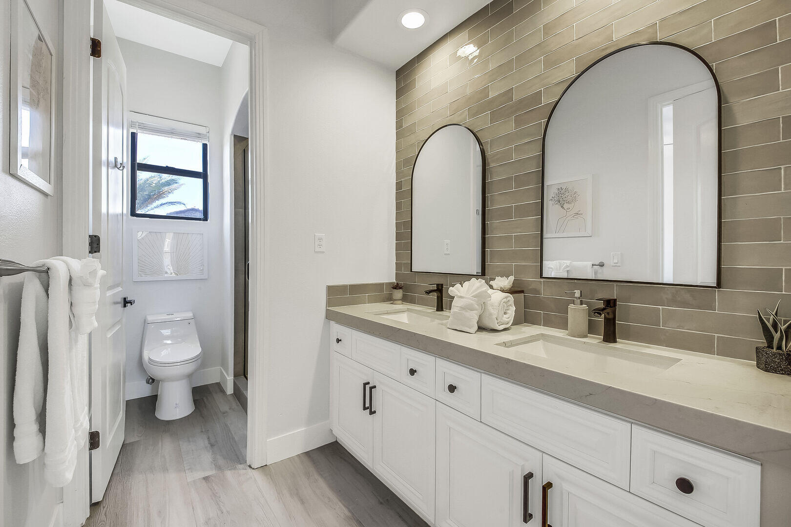 48573 Cascade Street Indio, CA 92201 - Photo 25 of 40 a en suite bathroom with a granite countertop toilet a sink and a mirror
