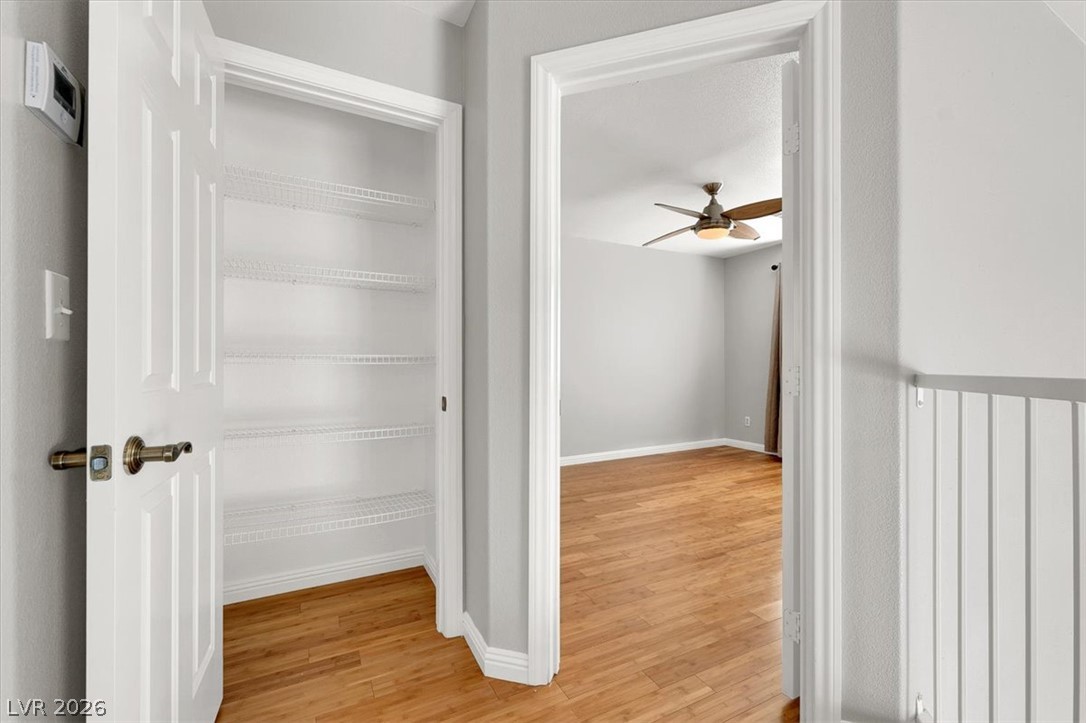 10148 Tree Bark Street Las Vegas, NV 89183 - Photo 20 of 37 A versatile closet offers ample storage adjacent to a naturally illuminated space with lustrous wood flooring.