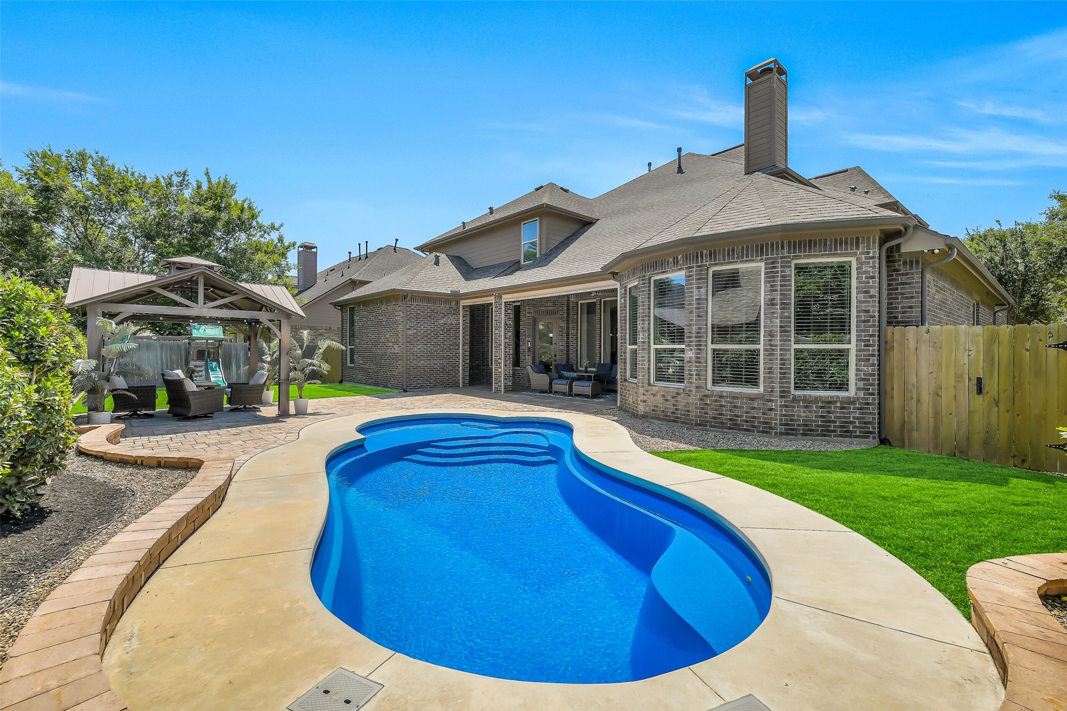 12207 Shorebridge Road Cypress, TX 77433 - Photo 39 of 41 a view of a house with a swimming pool and porch