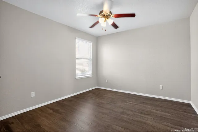 wooden floor in an empty room with a window