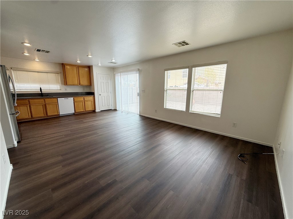 6228 Mercer Valley Street North Las Vegas, NV 89081 - Photo 11 of 41 Unfurnished living room featuring dark wood-style flooring, a textured ceiling, and recessed lighting