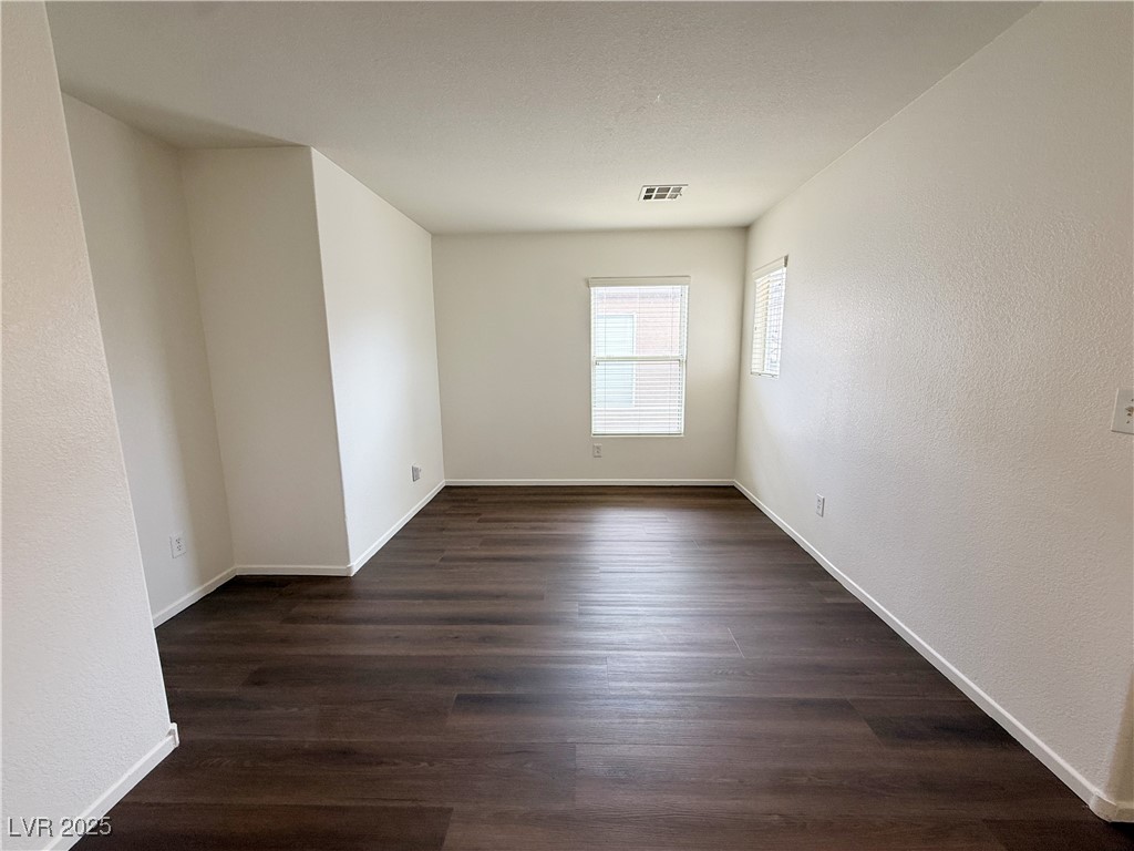 6228 Mercer Valley Street North Las Vegas, NV 89081 - Photo 16 of 41 Unfurnished room featuring a textured wall and dark wood-style flooring