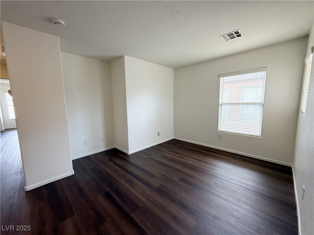 6228 Mercer Valley Street North Las Vegas, NV 89081 - Photo 18 of 41 Spare room featuring dark wood-style flooring and baseboards