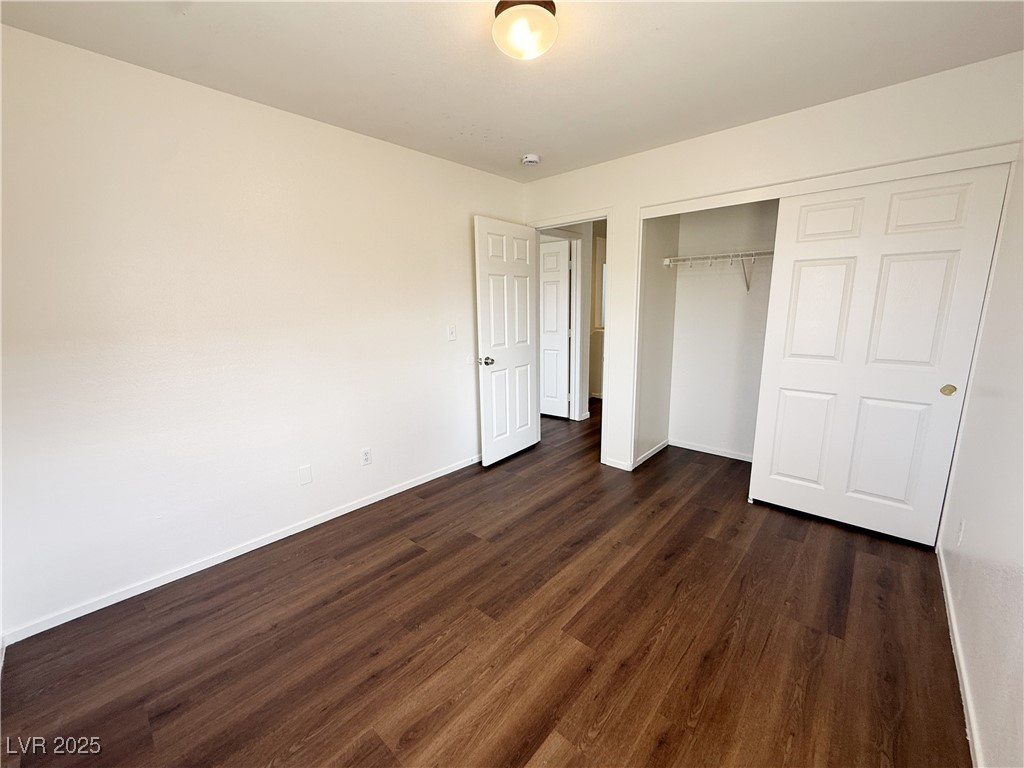 6228 Mercer Valley Street North Las Vegas, NV 89081 - Photo 21 of 41 Unfurnished bedroom featuring dark wood-type flooring and a closet