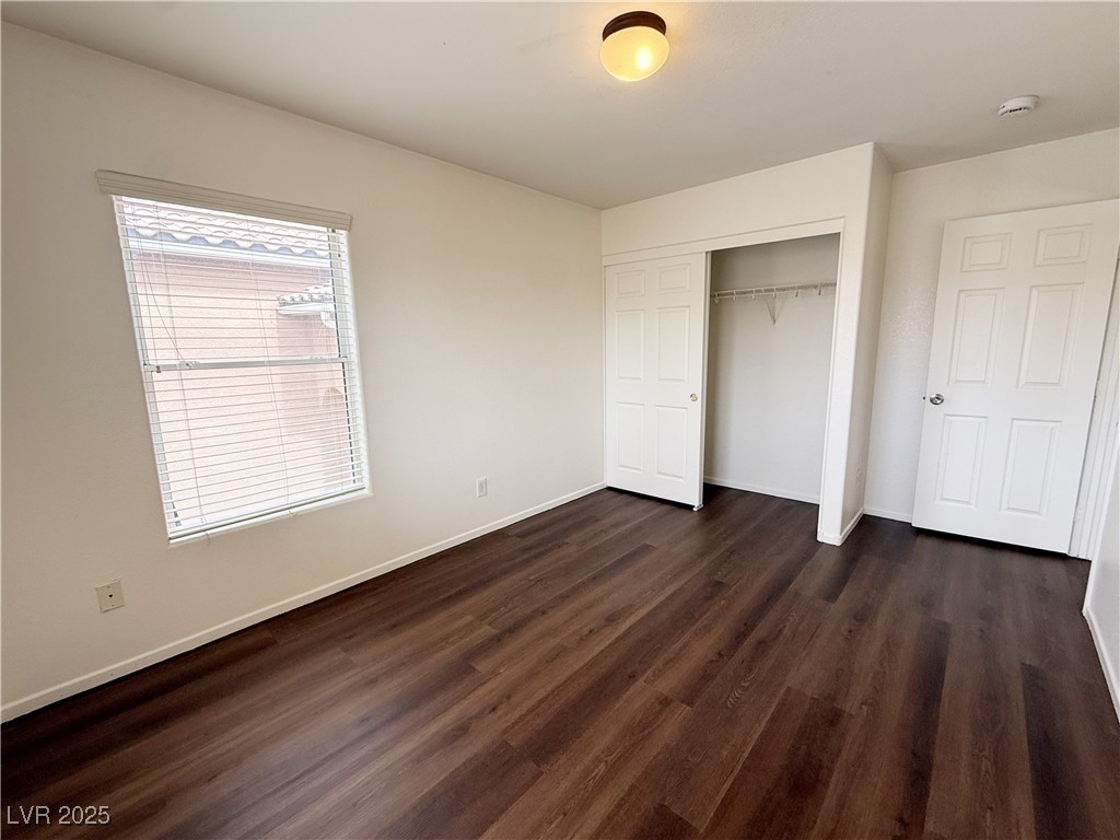 6228 Mercer Valley Street North Las Vegas, NV 89081 - Photo 24 of 41 Unfurnished bedroom featuring dark wood-style floors and a closet