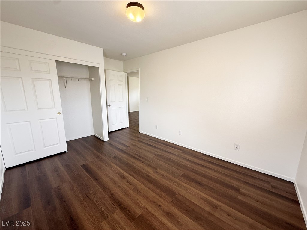 6228 Mercer Valley Street North Las Vegas, NV 89081 - Photo 25 of 41 Unfurnished bedroom featuring dark wood finished floors and a closet