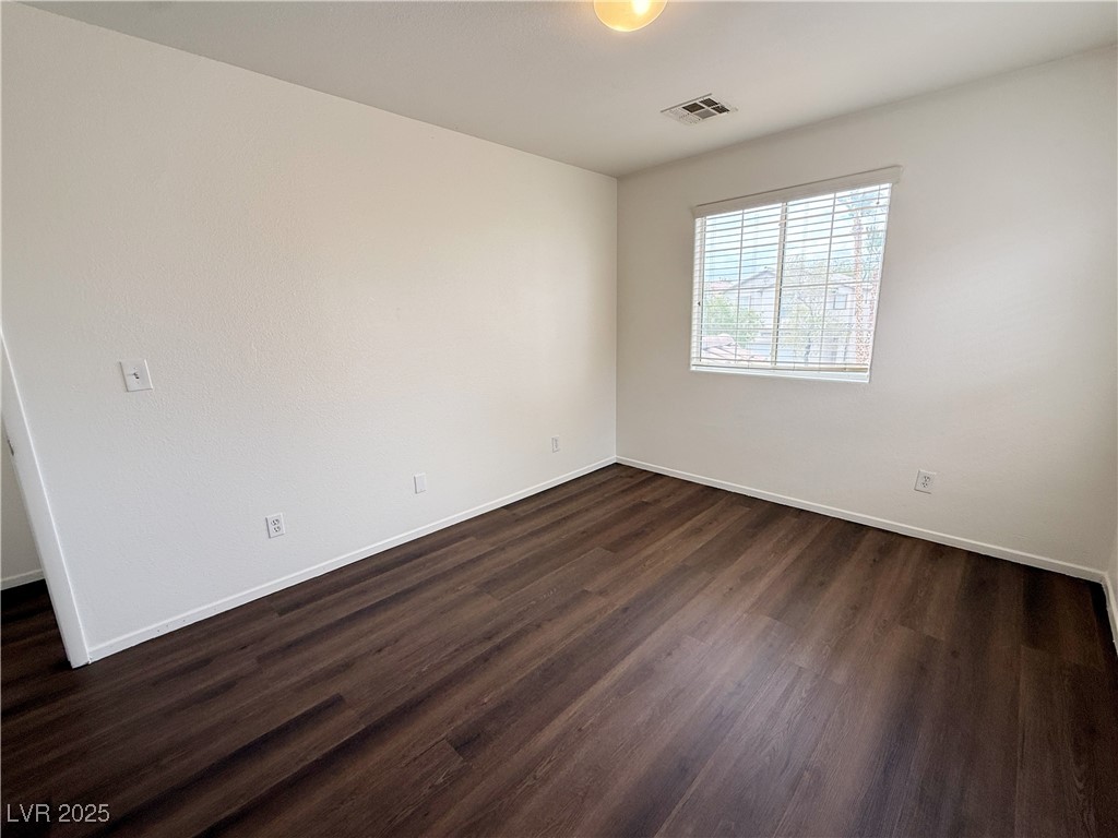 6228 Mercer Valley Street North Las Vegas, NV 89081 - Photo 26 of 41 Empty room with dark wood-style floors and baseboards