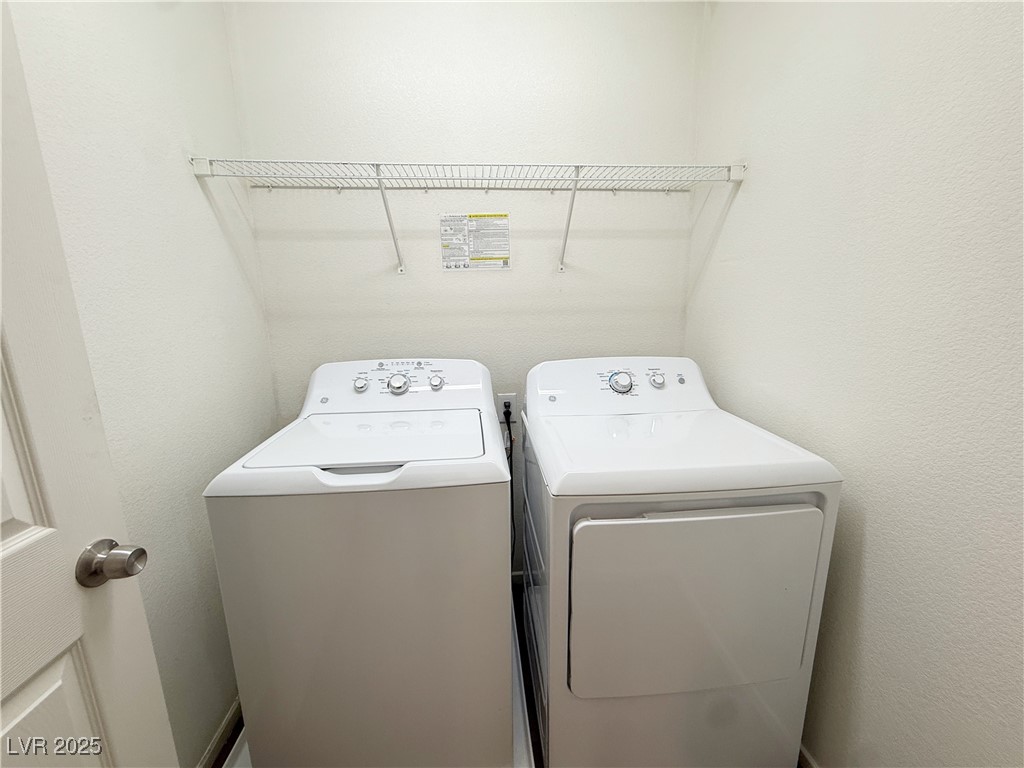 6228 Mercer Valley Street North Las Vegas, NV 89081 - Photo 27 of 41 Washroom with washing machine and dryer and a textured wall