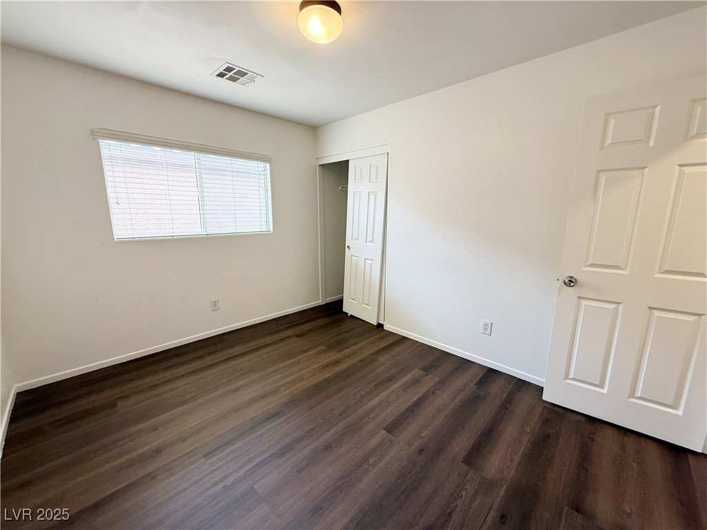 6228 Mercer Valley Street North Las Vegas, NV 89081 - Photo 31 of 41 Unfurnished bedroom with dark wood finished floors and a closet