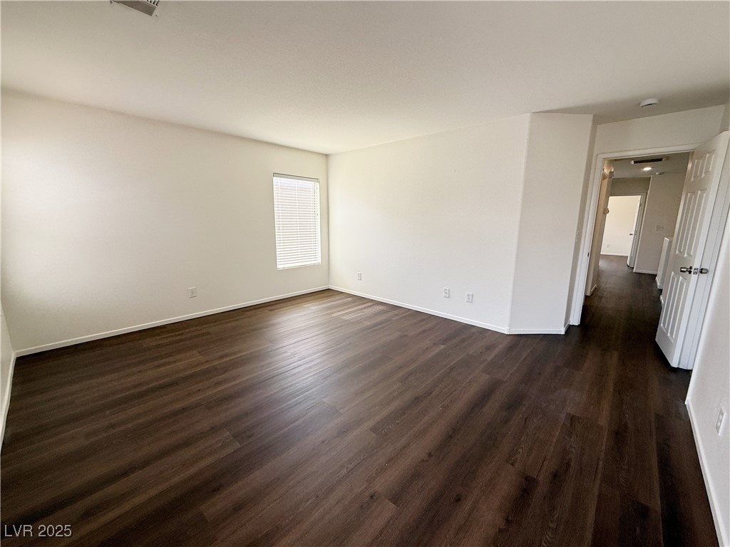 6228 Mercer Valley Street North Las Vegas, NV 89081 - Photo 33 of 41 Spare room with dark wood-type flooring and baseboards
