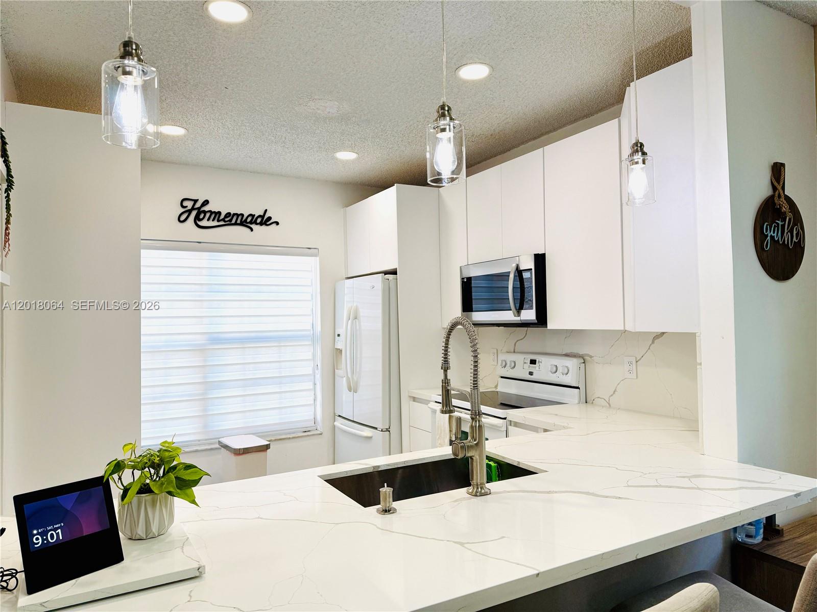 a kitchen with a sink a stove and a refrigerator