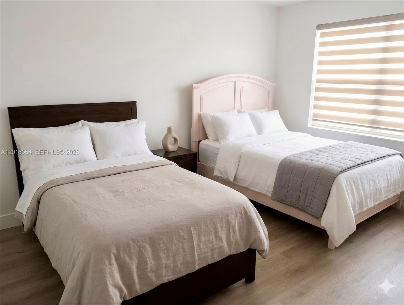 16213 Emerald Cove Road Weston, FL 33331 - Photo 11 of 27 a bedroom with two beds and a night stand