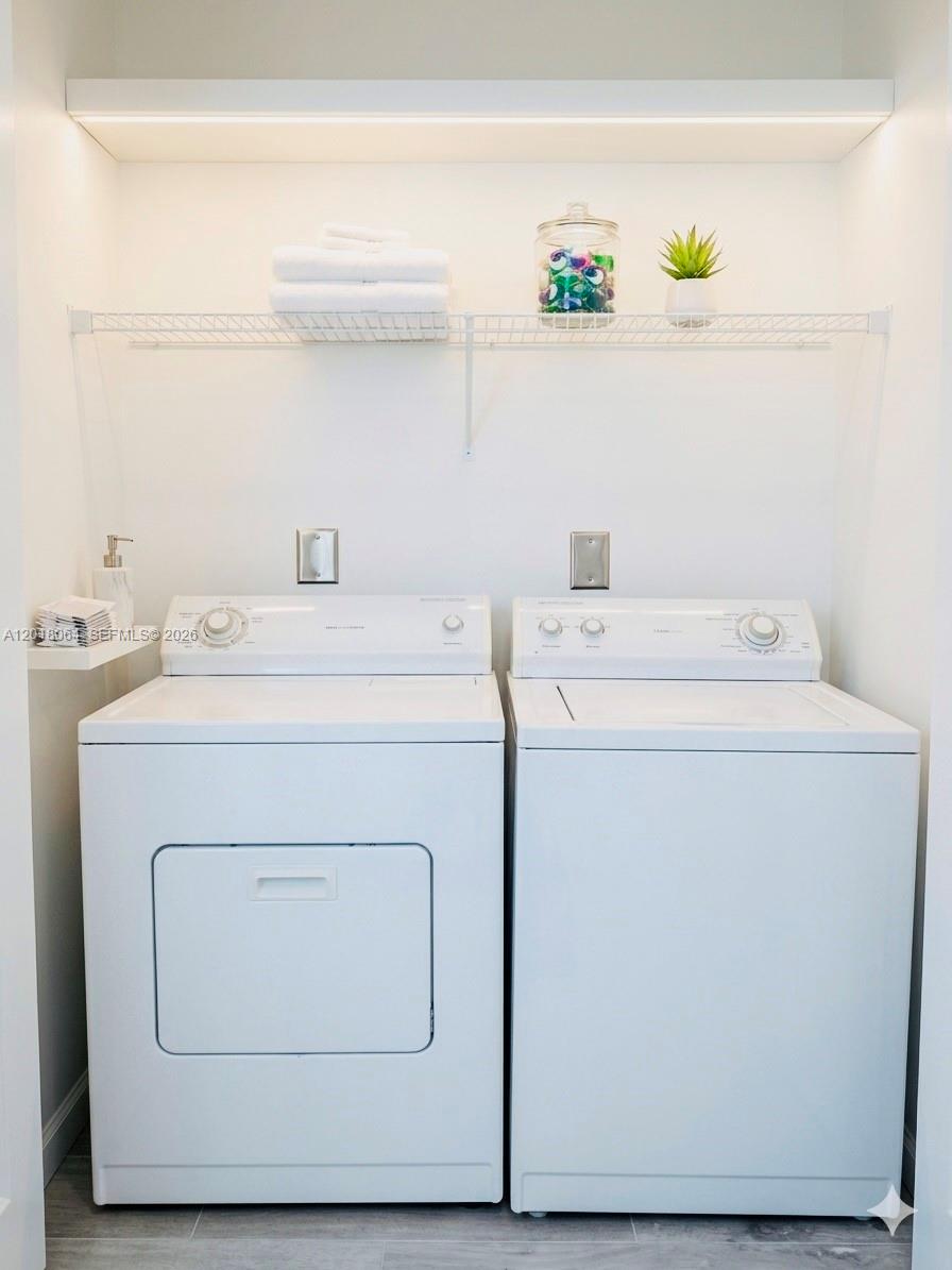 16213 Emerald Cove Road Weston, FL 33331 - Photo 17 of 27 a utility room with dryer and washer