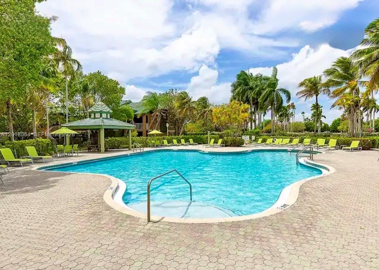16213 Emerald Cove Road Weston, FL 33331 - Photo 23 of 27 a view of a swimming pool with a yard