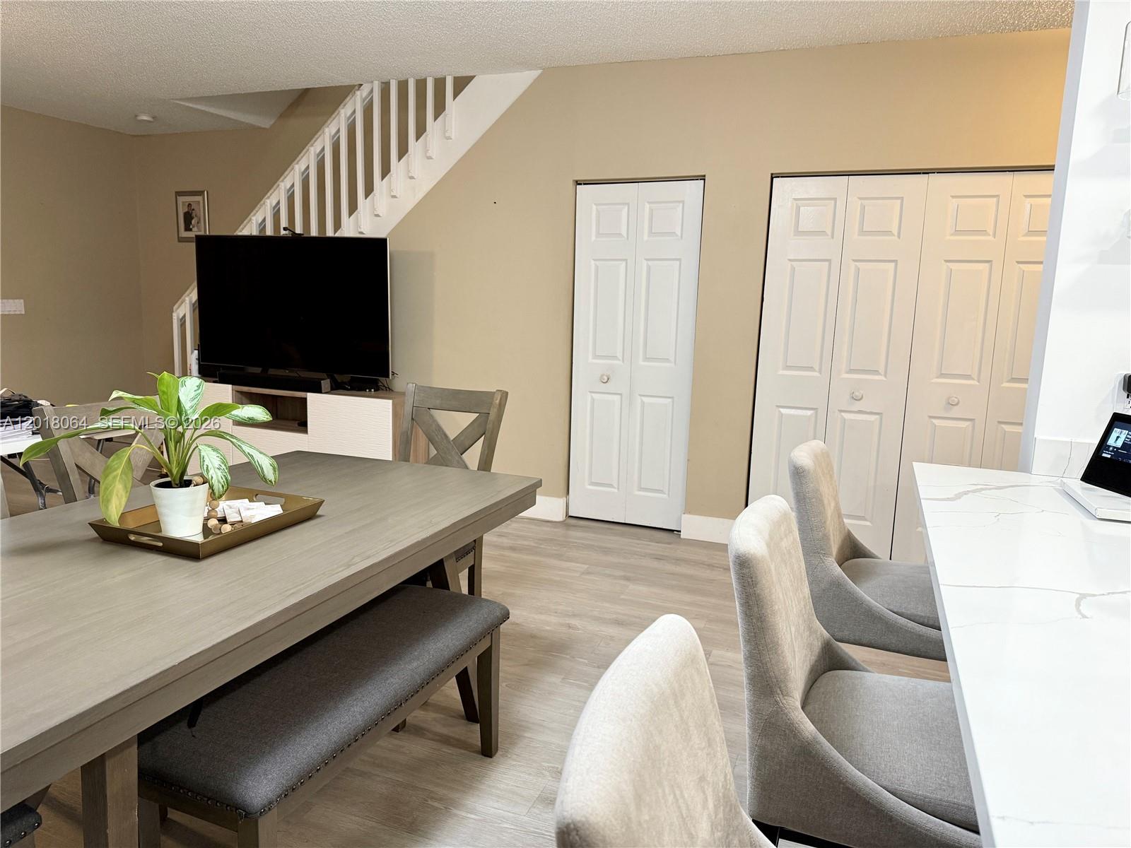 16213 Emerald Cove Road Weston, FL 33331 - Photo 5 of 27 a living room with furniture and a flat screen tv