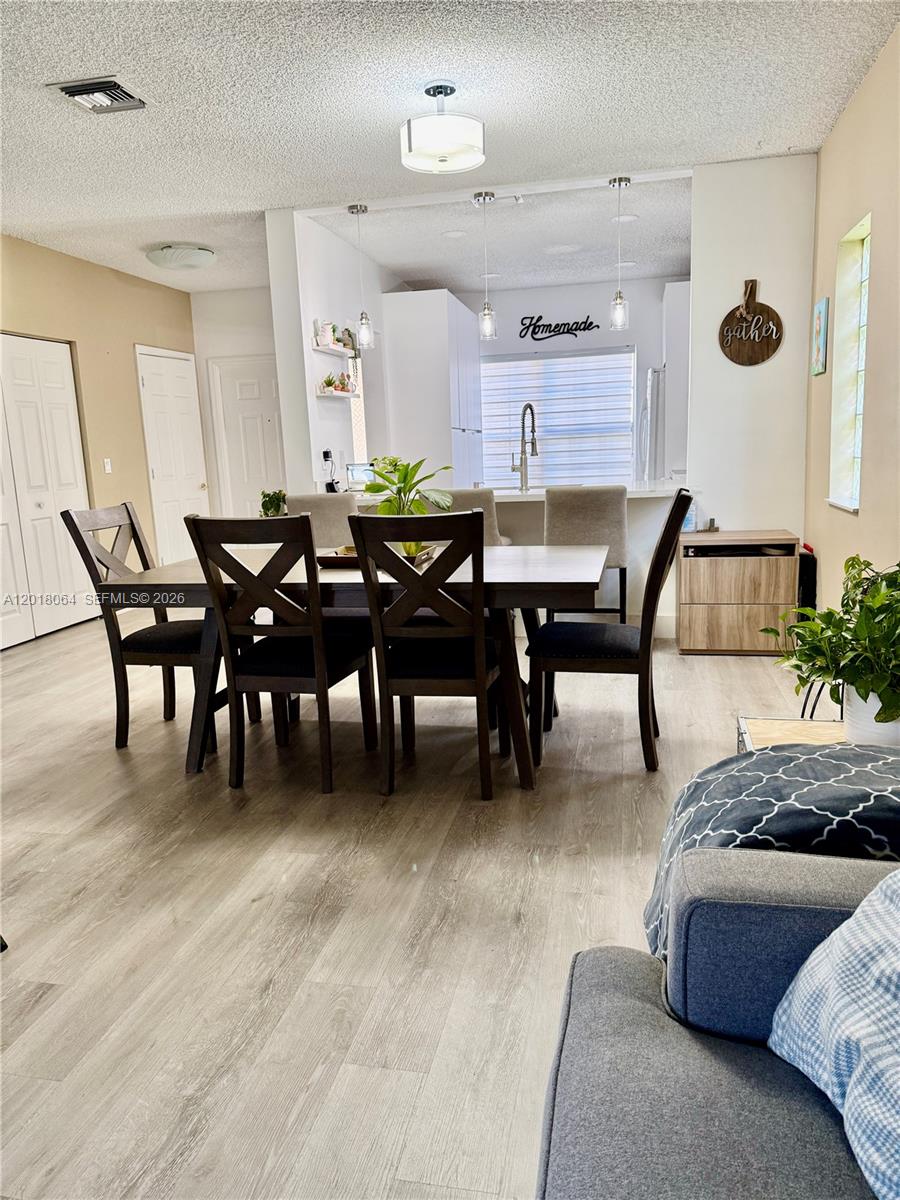 16213 Emerald Cove Road Weston, FL 33331 - Photo 6 of 27 a living room with furniture a dining table and a rug