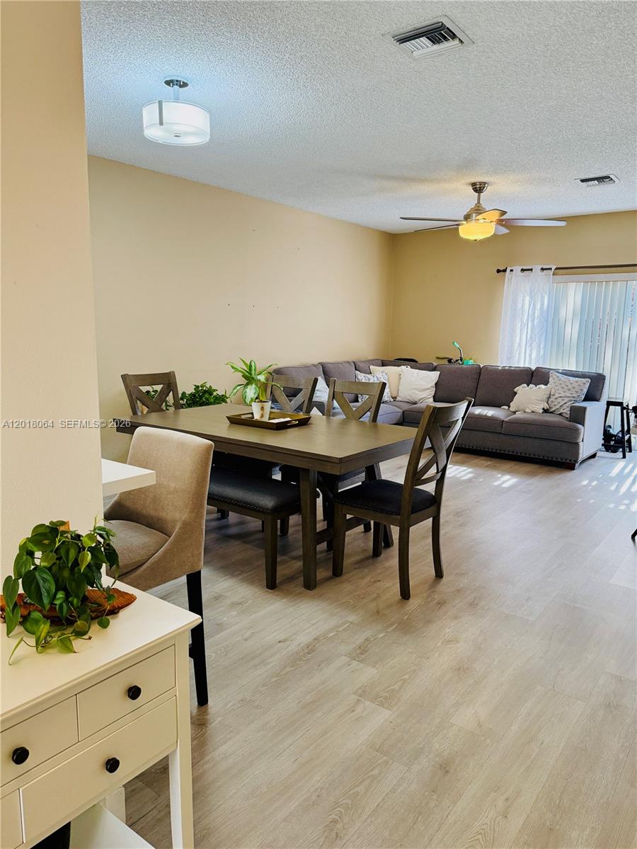 16213 Emerald Cove Road Weston, FL 33331 - Photo 7 of 27 a view of a dining room with furniture and chandelier