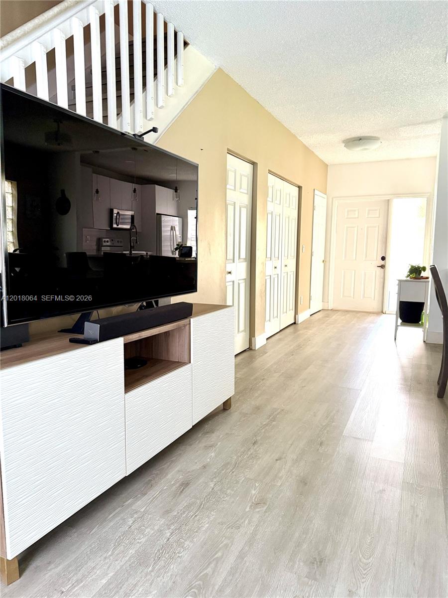16213 Emerald Cove Road Weston, FL 33331 - Photo 8 of 27 a kitchen with granite countertop a stove and a refrigerator