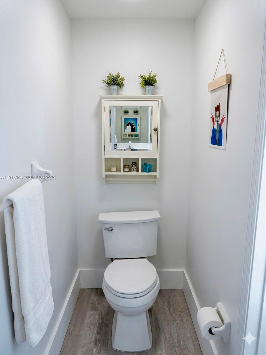 16213 Emerald Cove Road Weston, FL 33331 - Photo 9 of 27 a bathroom with a toilet and a sink