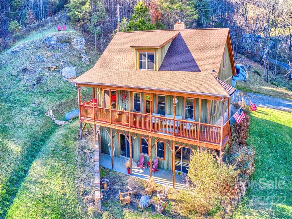 879 Lost Cove Road Clyde, NC 28721 - Photo 3 of 42 a aerial view of a house with swimming pool