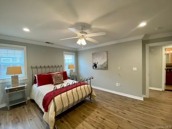 a bedroom with a bed and a ceiling fan