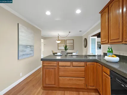 a kitchen with granite countertop cabinets and window