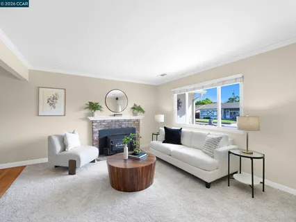 a living room with furniture a fireplace and a window