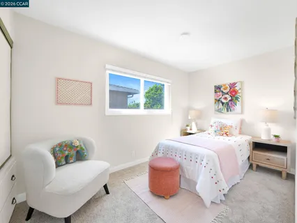 a spacious bedroom with a bed and a window