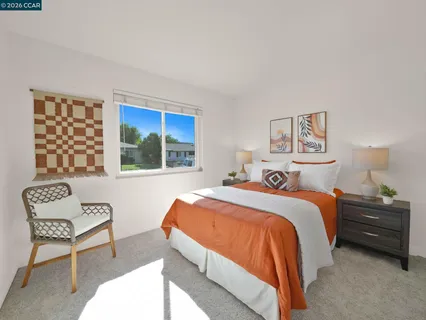 a bedroom with a bed and flowerpot