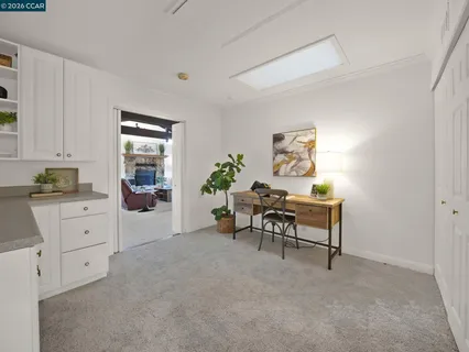a kitchen with white cabinets and white appliances