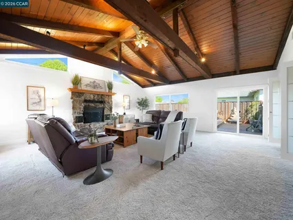 a living room with furniture a fireplace and a table