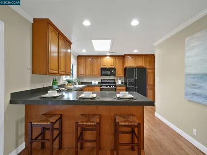 a kitchen with a sink cabinets and wooden floor