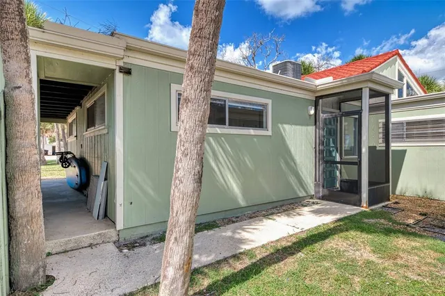 a view of a house with backyard porch and sitting area