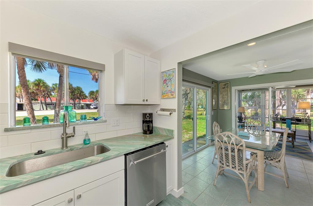 2985 North Beach Road, Unit C53 Englewood, FL 34223 - Photo 11 of 67 a kitchen with a sink and wooden cabinets