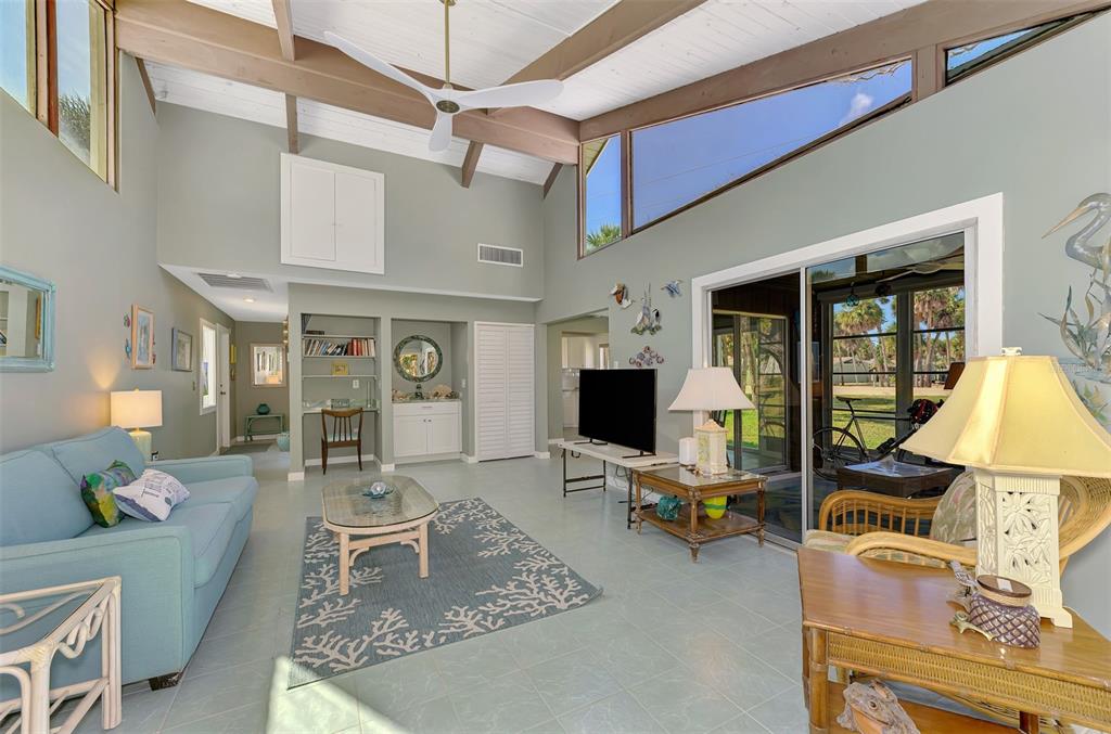 2985 North Beach Road, Unit C53 Englewood, FL 34223 - Photo 20 of 67 a living room with furniture a rug and a flat screen tv