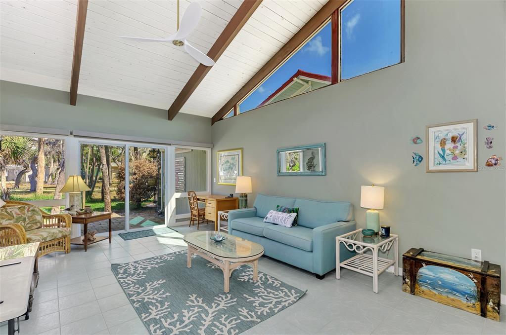 2985 North Beach Road, Unit C53 Englewood, FL 34223 - Photo 24 of 67 a living room with furniture and a floor to ceiling window